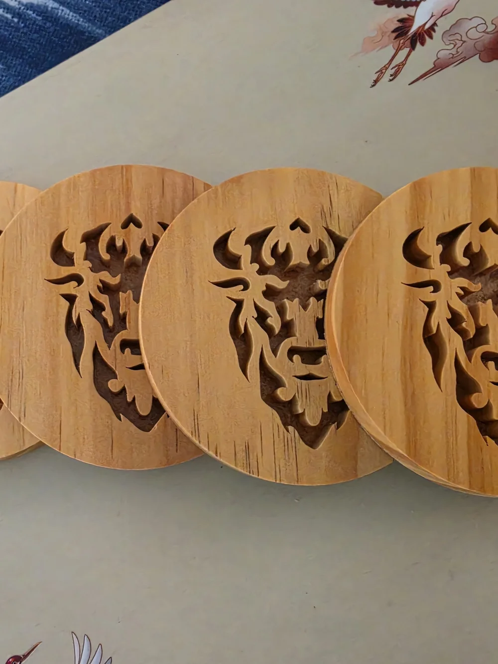 Four Wooden drink coaster set Intricate, stylized bison/buffalo head silhouette